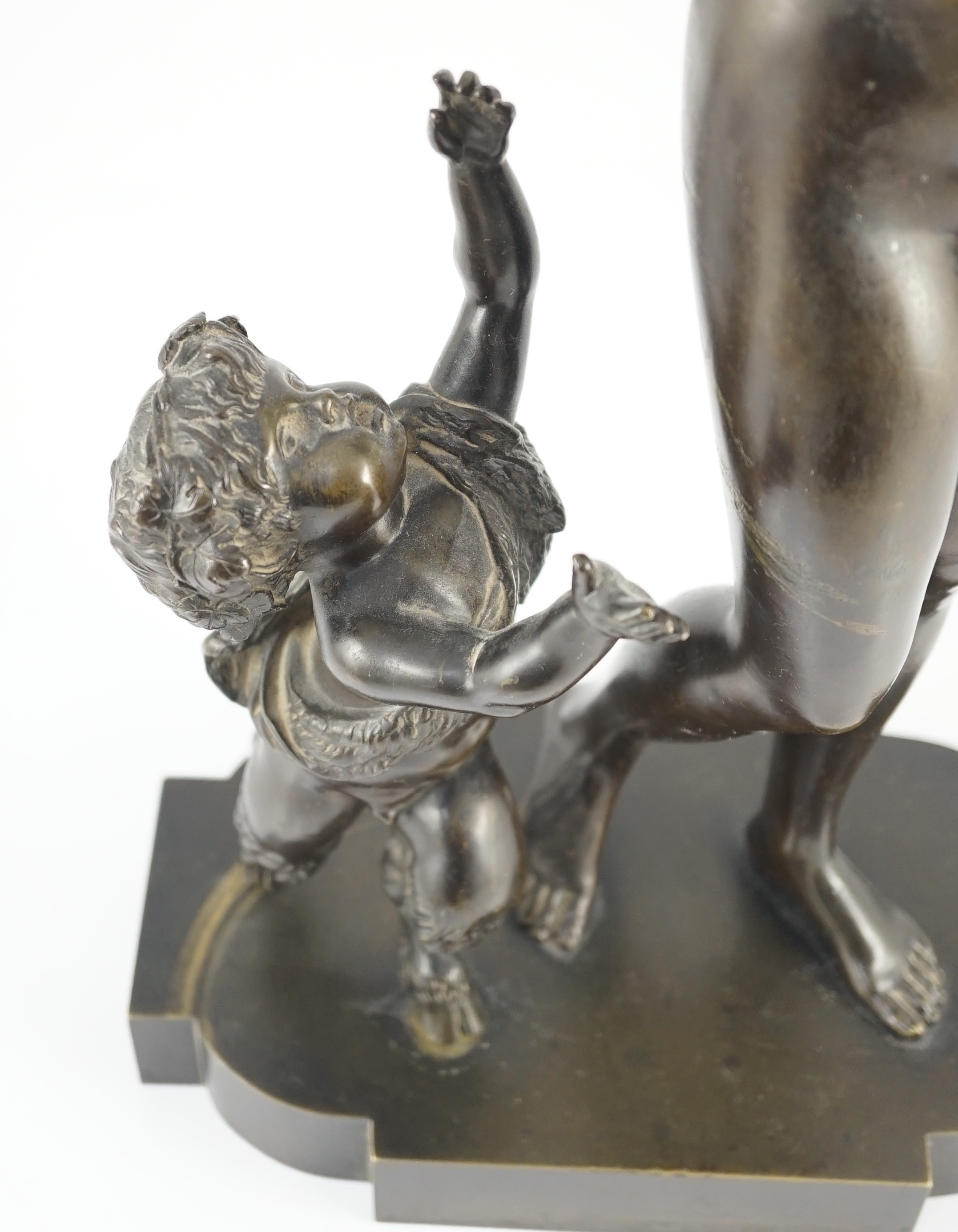 A 19th century French bronze group of a muse dancing alongside a faun, 24cm wide, 52cm high